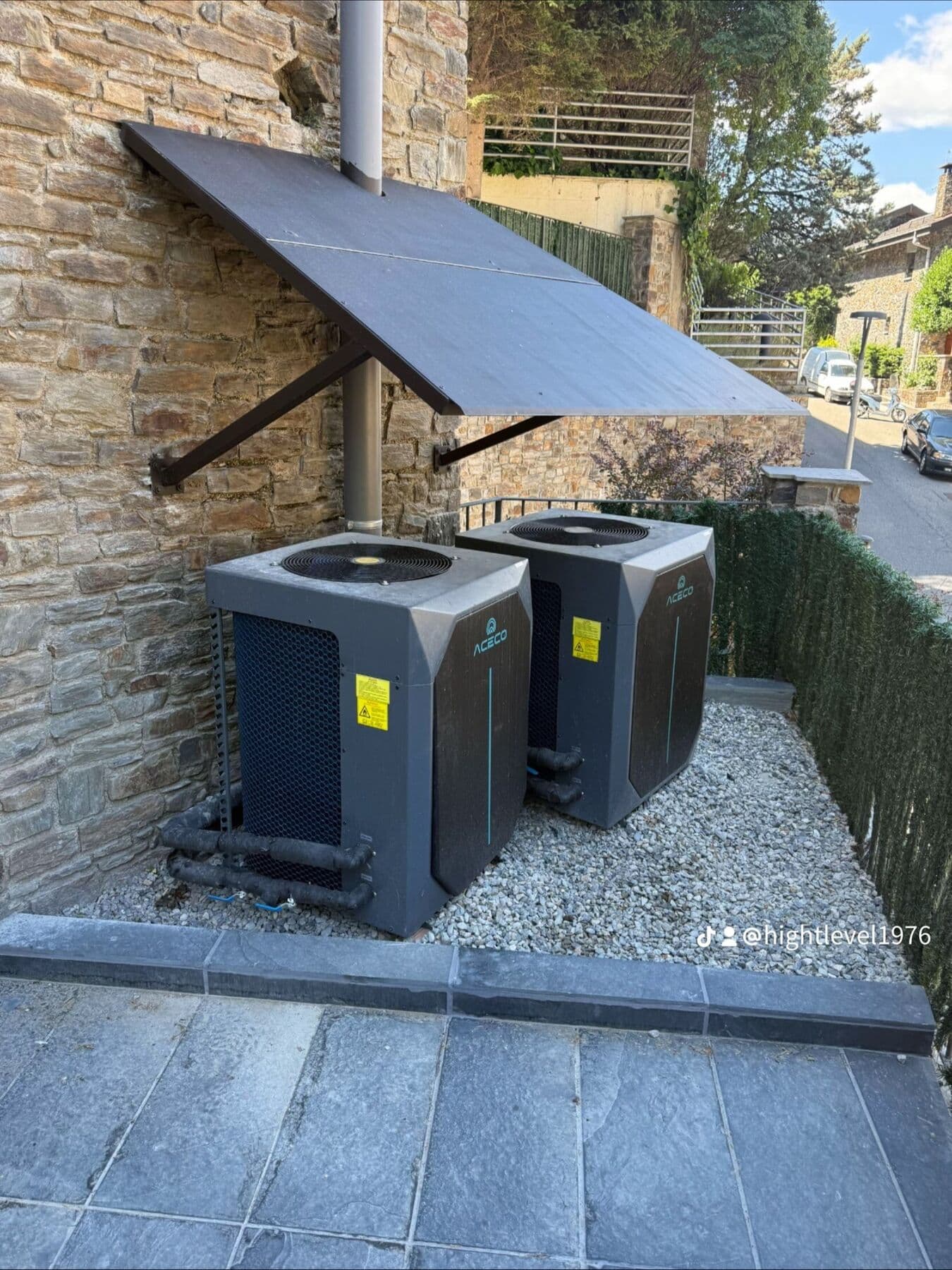 Two ACECO heat pumps under a metal canopy